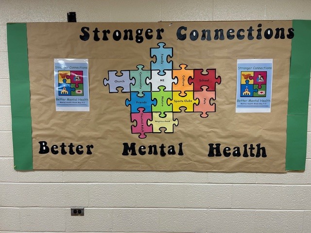 A bulletin board with a Mental Health Week poster: Stronger connections, better mental health